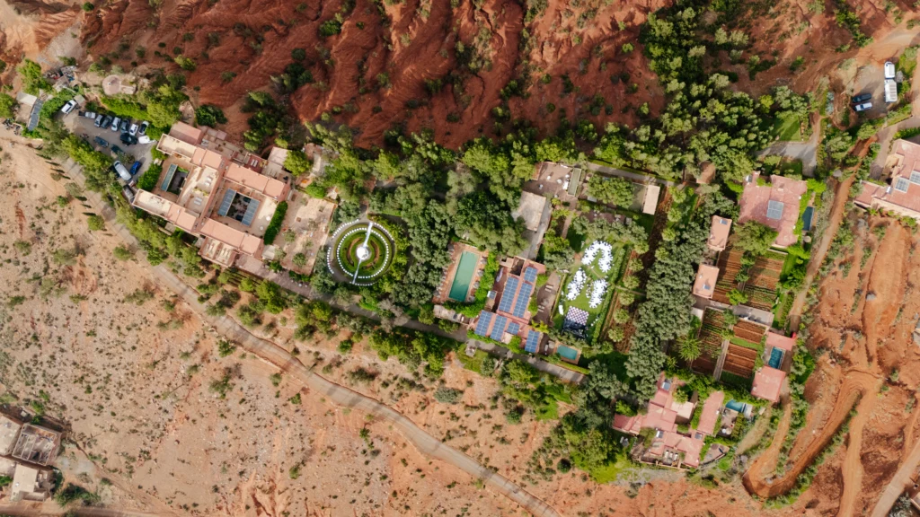 aerial view of a resort with a fountain and trees