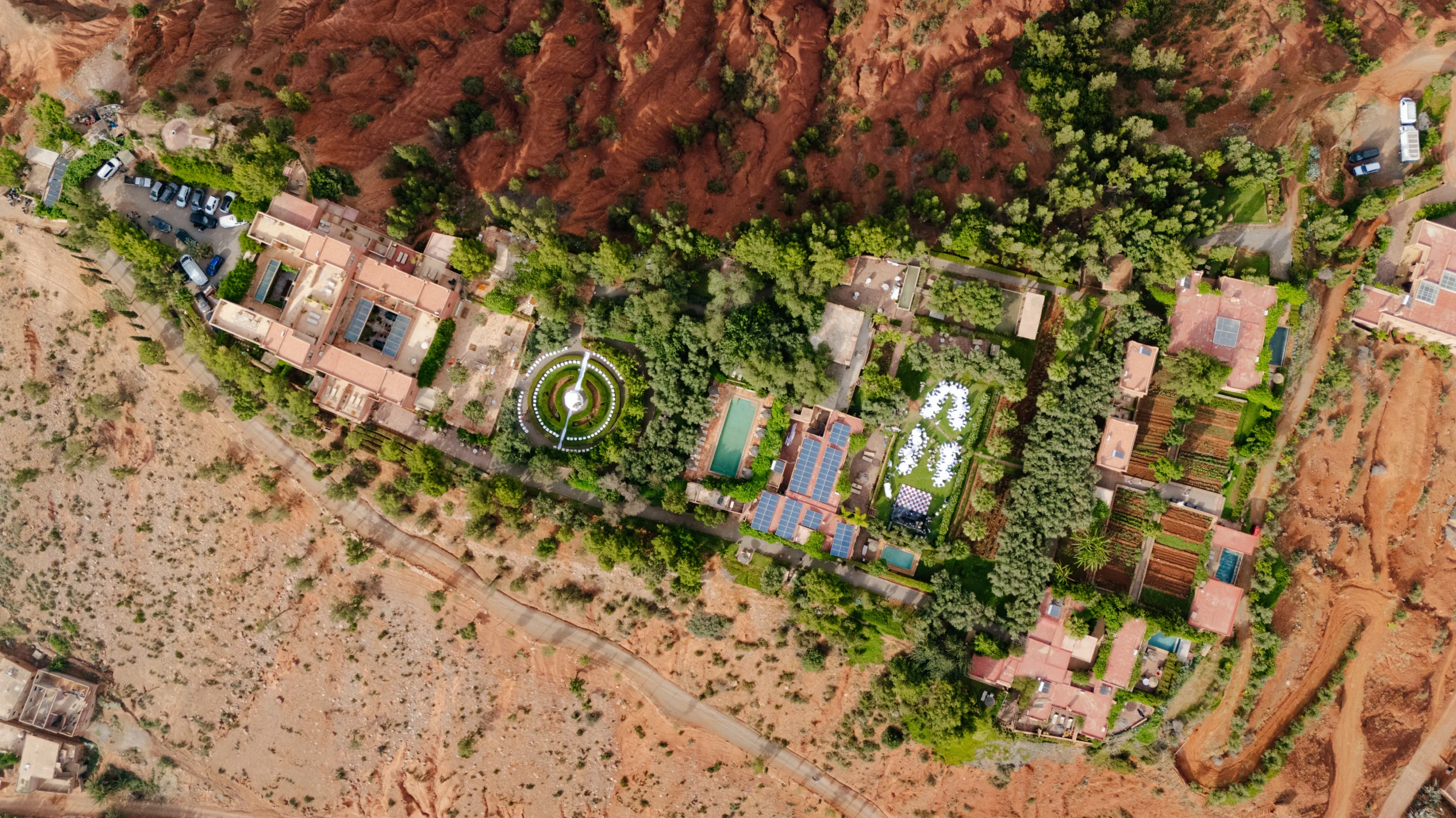 aerial view of a resort with a fountain and trees